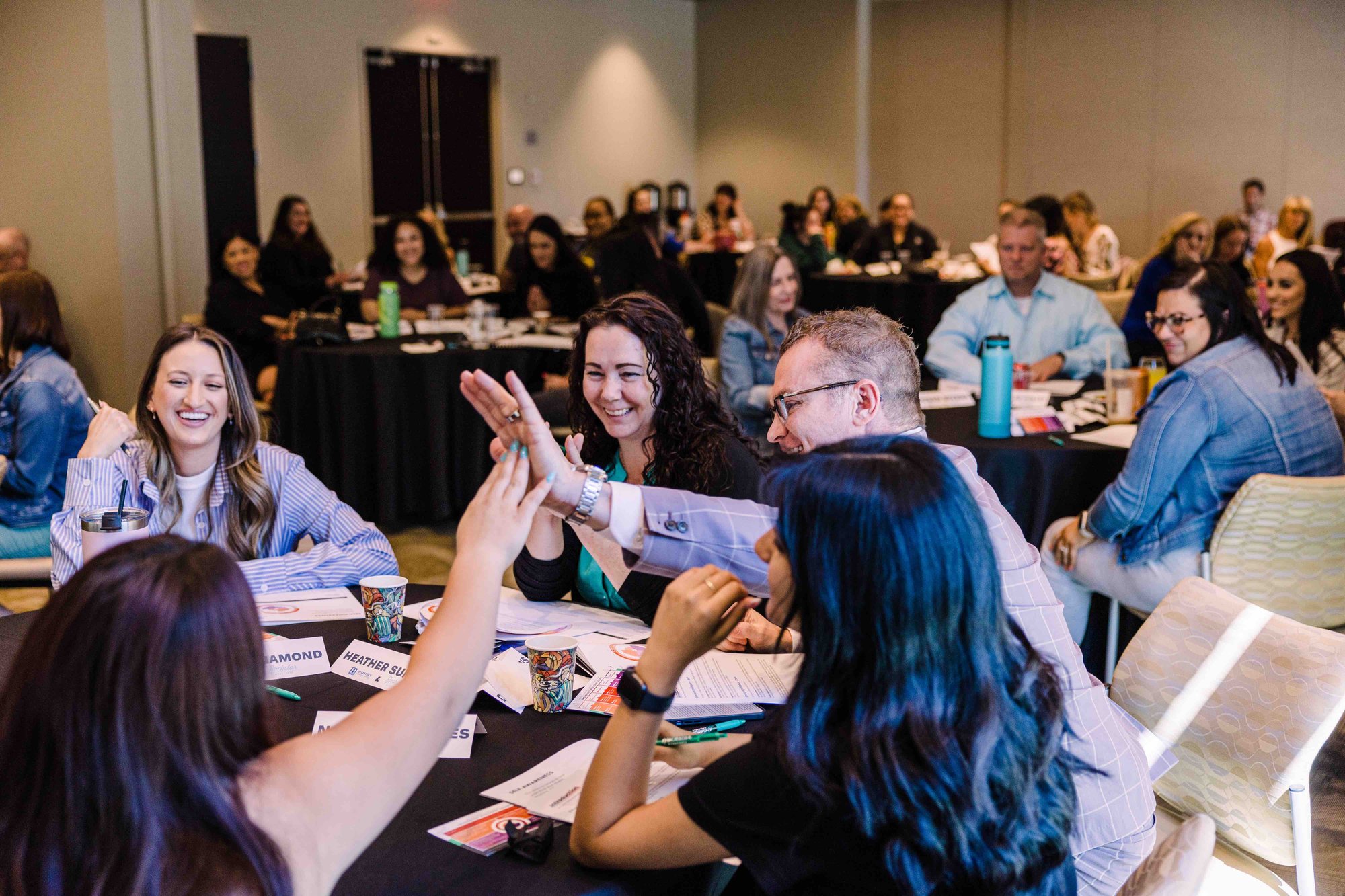 Participants Clapping at Table